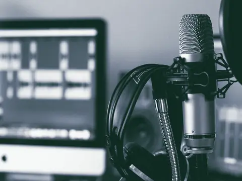 Headphones resting on a studio microphone