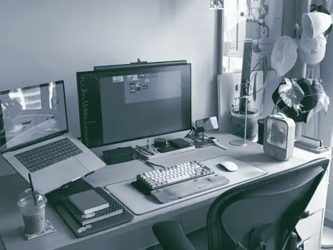 Desk with a laptop and monitor set up for web work